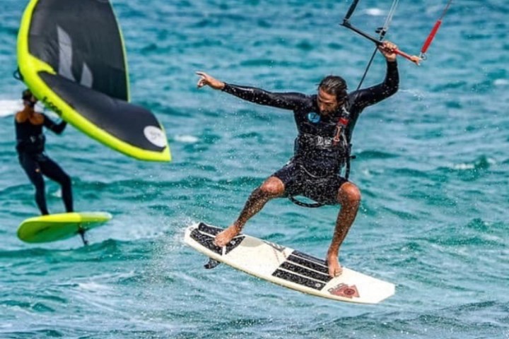 a man riding a surfboard on top of a body of water