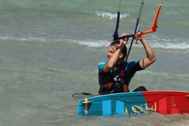 a person riding a surf board on a body of water