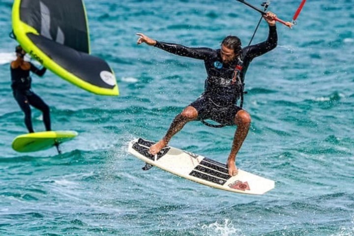 a man riding a wave on a surfboard in the ocean